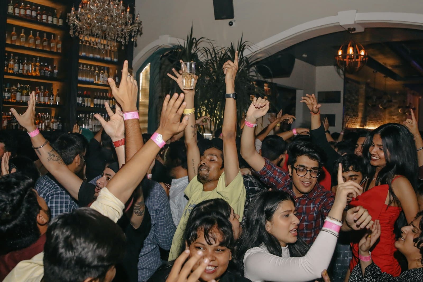 Friends dancing with their hands up at a house party