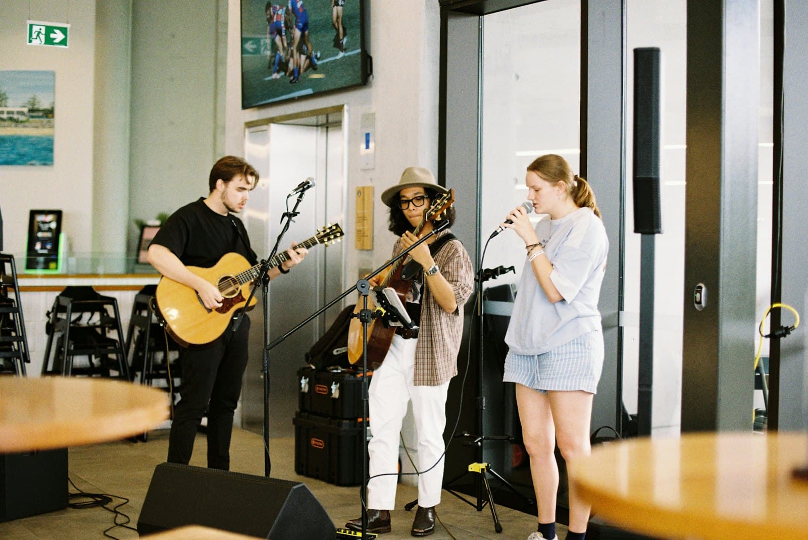 Three musicians playing live in a cosy venue